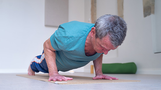 A man does yoga on a mat